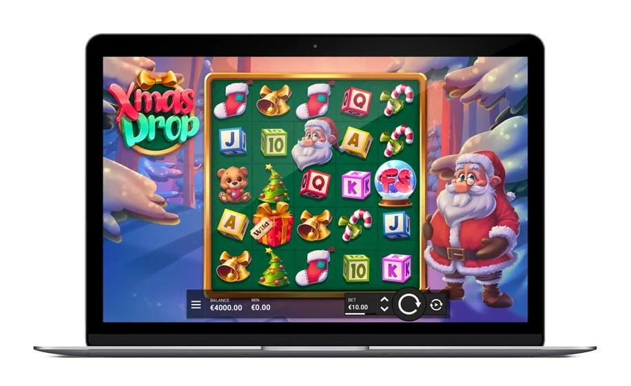Xmas Drop slot by Hacksaw Gaming on desktop with Santa beside the 5x5 reels